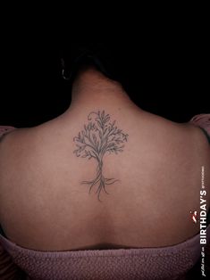 a woman with a tree tattoo on her back