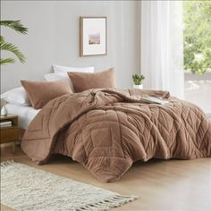 the comforter is made up and ready to be used in the bedroom or living room