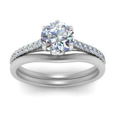 a white gold engagement ring set with an oval cut diamond and pave diamonds on the band