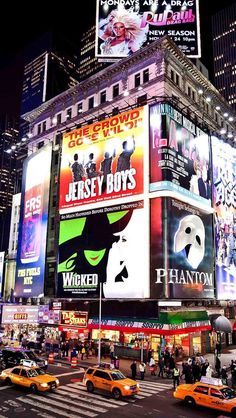 the times square in new york city is lit up at night with neon signs and advertisements