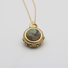 "*Our current stock of green opal is a dark mossy green* A spring-loaded locket pops open to reveal 2 hinged panels, just 1\" in diameter.  It opens to hold 4 photographs. The feature of this unique locket is a green opal.  This is considered a cleansing and rejuvenating stone. These are natural stones and each one will be different.  ~Comes on a 24\" chain" Unique Locket Necklace Silver, Family Heirloom Jewelry, Unique Locket Necklace, Unique Locket, Necklace Family, Mossy Green, Family Jewels, Dope Jewelry, Family Album