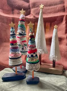 three small christmas trees made out of fabric