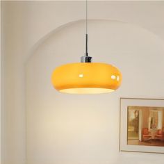 a yellow light hanging from the ceiling in a room