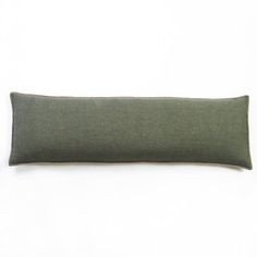 a green pillow on a white surface with a black border around the edges and bottom