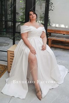 a woman in a white dress sitting on a bench