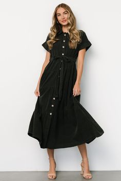 Baltic Born exclusive style Washed black color Cotton-poly blend material has no stretch Collared Functional buttons down front of dress Cuffed short sleeves Removable self-tie waist sash Tiered maxi length Unlined 90% Cotton, 10% Polyester Casey is 5'8, cup size 32B, size 2 and wearing size S Summer Short Sleeve Belted Dress With Buttons, Summer Belted Dress With Buttons And Short Sleeves, Casual Black Belted Dress For Spring, Black Shirt Dress With Tie Waist For Summer, Chic Short Sleeve Belted Dress With Button Closure, Black Casual Dress With Tie Fastening, Casual Black Belted Dress, Short Sleeve Belted Midi Dress For Casual Wear, Short Sleeve Belted Dress With Buttons For Work