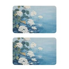 two placemats with white flowers and leaves on blue water, set of 2