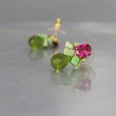 Gift for Women, Pink Green Stud Earrings, Colorful Stud Earrings, Stud Earrings, Unique Posts, Pink Gifts, Colorful Earrings, Unique StudsA pair of feminine and fun bee stud earrings! Made from sparkling pink cubic zirconia set on a copper base. The bee wings are made of chrysoprase and delicate green glass dangles down and gives it a whimsical look. A unique handcrafted eye catching jewelry piece!They come with silicone backs, for your comfort and security.The post is made of gold filled. The e Green Cluster Earrings Gift, Green Cluster Earrings As A Gift, Multicolor Cluster Earrings As Gift, Green Stud Earrings, Colorful Stud Earrings, Bee Wings, Unique Studs, Bee Studs, Stud Earrings Unique