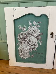 an old door with flowers painted on it