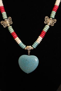 You can pick and choose your favorite color 'Dyed Howlite Stone Heart Pendant'--which are available in 3 colors--Coral; Turquoise; Bone.  Each necklace has 4-different colors in the donut beads--Turquoise Blue; Turquoise Green; Bone; Coral--which match perfectly with the Heart Pendants.  All the beads in this necklace set are 'Dyed Howlite Stone Beads' that resemble real Turquoise but without the real cost!  Each necklace also has four 'Silver Metal Butterflies' and metal silver accent pieces such as silver beads; metal bails which may have a flower accent or a heart design (depending on inventory).  This necklace also features an extra large lobster clasp for an easy connection.  Earrings are also included in the price of this beautiful set.   Heart Pendant size:  1 1/2" x 1 1/2" Colorful Heart-shaped Beaded Jewelry, Blue Heart-shaped Jewelry With Colorful Beads, Multicolor Heart Pendant Jewelry With Heart Beads, Adjustable Blue Heart-shaped Beaded Necklaces, Adjustable Blue Heart-shaped Beaded Necklace, Multicolor Heart Pendant With Colorful Beads, Blue Adjustable Heart-shaped Beaded Necklaces, Adjustable Blue Heart Beaded Necklaces, Multicolor Heart Beads Jewelry For Valentine's Day