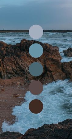 an image of the ocean and rocks with circles on them that look like they are floating in the air