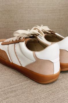 The Dixie Camel & White Lace Up Sneaker, a stylish and versatile addition to your footwear collection. These sneakers feature a sleek camel and white faux leather upper, offering a contemporary and chic look. The round toe design ensures comfort and ample space for your toes, while the lace-up details provide a secure and adjustable fit. The brown rubber sole offers excellent durability and traction, making these sneakers perfect for everyday wear. Whether you're running errands, heading to the Faux Leather Purse, Studded Necklace, Travel Dress, Faux Leather Belts, Footwear Collection, Jumpsuit Shorts Rompers, Bar Earrings, Romper Pants, Sunglasses Sale