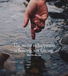 a person's hand reaching out to the water with a quote on it that reads, the secret to happiness is flowing, not forging