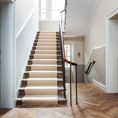 a staircase with carpeted steps leading up to the second floor