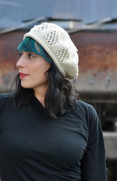 a woman with green hair wearing a white knitted hat and black t - shirt