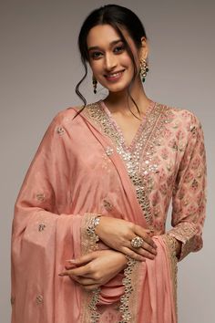 Editor's Note This pretty ensemble in this Nusrat floral jaal, combines gota and dori buttis with an intricate border embroidery. The short tunic with matching dupatta embroidered in sequins and gold thread, and voluminous sharara adds a feminine grace. Fabric: Dupatta: crepe, kurta: georgette, sharara: georgette Color: Pink Component: Sharara, kurta and dupatta Occasion: Festive Note: Product colour may slightly vary due to photographic lighting sources Care: Dry Clean Only About the Designer G Chikankari Embroidery Salwar Kameez With Kundan, Pink Dola Silk Palazzo Set For Diwali, Pink Dola Silk Palazzo Set With Dupatta, Festive Chikankari Embroidered Dola Silk Sharara, Festive Pink Dola Silk Palazzo Set, Pink Dola Silk Palazzo Set With Resham Embroidery, Pink Palazzo Set With Resham Embroidery In Dola Silk, Pink Chinon Unstitched Suit With Gota Work, Bollywood Style Dola Silk Sharara With Chikankari Embroidery