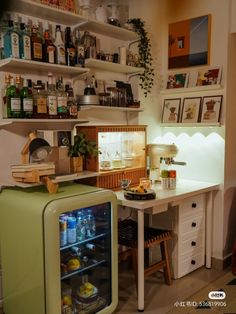 a small refrigerator sitting in the middle of a kitchen next to shelves filled with bottles