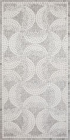 a white and gray rug with circles on it