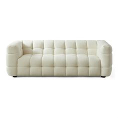 a white couch sitting on top of a white floor