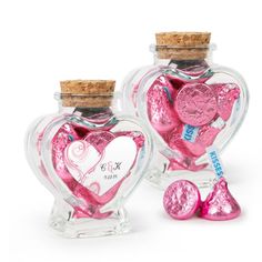 two heart shaped bottles filled with candy