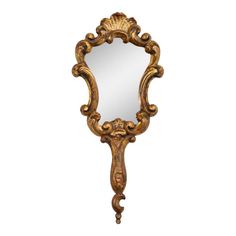 an ornate gold framed mirror on a white background