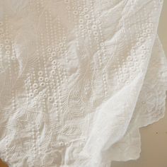 an image of a white table cloth on the floor