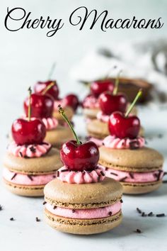 several cookies with cherries and whipped cream on them are arranged in the shape of sandwiches