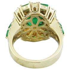 Stamped: 14K Total Ring Weight: 11.8 Grams Emerald Weight 3.20 Carat (9.00x7.00 Millimeters)Side Emerald Weight 2.00 CaratDiamond Weight: 1.70 carat (F-G Color, VS2-SI1 Clarity )Face Measures: 20.70x17.75 Millimeter SKU: [600419] Luxury Pear-shaped Emerald Ring For Formal Occasions, Luxury Green Oval Cluster Ring, Luxury Green Cluster Ring For Formal Occasions, Luxury Green Cluster Ring For Formal Events, Luxury Green Halo Ring For Formal Occasions, Yellow Gold Diamond Ring, Gold Diamond Ring, Gold Diamond Rings, Precious Metals