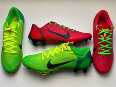 three pairs of nike soccer cleats, one in red and the other in green