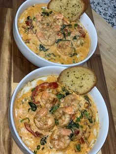 two white bowls filled with shrimp and grits