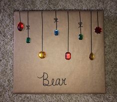 a piece of paper with beads hanging from it's sides and the word bead written on it