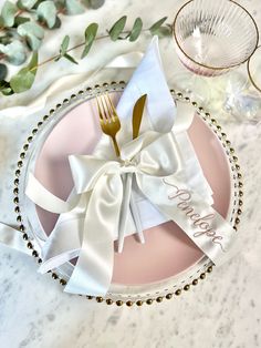 a pink plate topped with a fork and knife