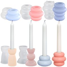 there are many different colored candles and vases