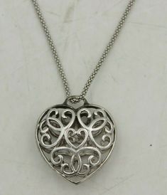 "Beautiful 3D Filigree Heart Pendant Sterling Silver 925 Italy 18\" Necklace Pendant Height: 1\"  Pendant Width: 1\" inch Pendant Weight: 5 grams Necklace Length: 18\" Necklace Weight: 3 grams Stamped: 925 Italy Original Patina, This item will not and has not been cleaned Item will arrive as pictured This Item has been acid tested to confirm it is real Sterling Silver  10% restocking fee on returns  Metal Purity925 parts per 1000 MetalSterling Silver" Valentine's Day Anniversary Necklace With Filigree Details, Valentine's Day Anniversary Filigree Necklace, Anniversary Filigree Heart Pendant Necklace, Silver Heart Locket Necklace For Anniversary, Formal Sterling Silver Round Heart Necklace, Sterling Silver Round Heart Necklace For Formal Events, Elegant Silver Heart Locket Necklace, Round Sterling Silver Heart Necklace For Formal Occasions, White Gold Hallmarked Heart Necklace For Valentine's Day