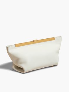 The Aimee Clutch by Khaite is a sleek handheld bag featuring a golden brass frame and an engraved clasp closure. This variation is crafted from smooth white calfskin and includes an interior card pocket and protective brass feet.[tab] Composition: 100% Calfskin Size and Fit: Runs True to Size. 11.75 inches long, 6 inches wide, 5.25 inches deep. Care Instructions: Professional Clean Origin: Imported SKU: KHA49R009-WGO Questions about size, fit, or how to style? The KZ team is here to help you loo Neutral Bag, Clean Origin, Have Metal, Leather Clutch Bags, Van Cleef Arpels, Brass Frame, Logo Stamp, Brown Fashion, Lady Dior