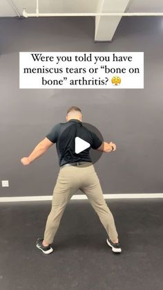 a man standing in front of a gray wall with an ad on it that says, were you told you have menis tears or bone arthriis?