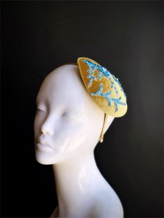 This chic headpiece features a teardrop-shaped base in a rich golden hue, beautifully adorned with blue floral lace and delicate beadwork. Ideal for weddings, garden parties, and tea parties, this fascinator add charm to any outfit. Age Group/Gender - Adult/Women Size/Type - One size fits all adults Color - Gold/Blue Material - Velvet and beaded lace fabric Special Features - Floral lace design Elegant Headpiece With Teardrop Crown For Gift, Elegant Headpieces With Teardrop Crown For Gift, Elegant Teardrop Crown Headpiece For Gifts, Adjustable Teardrop Crown Costume Hat For Parties, Gold Teardrop Crown Headband For Parties, Elegant Gold Teardrop Crown Headband, Handmade Gold Headpiece With Pinched Crown, Elegant Handmade Teardrop Crown Headpiece, Handmade Gold Headpiece With Teardrop Crown