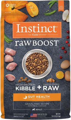 an open bag of raw dog food with meat and vegetables on the side, including carrots