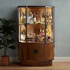 a wooden cabinet filled with lots of liquor bottles