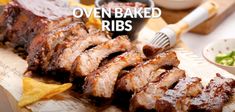 barbecue ribs and potato chips on a table with the words oven baked ribs above it