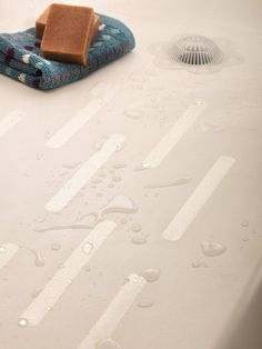 a bathtub with soap on it and water droplets