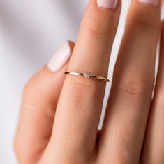 A dainty 14K gold solitaire ring with a tiny diamond 2mm. This stacking diamond ring can be an affordable engagement ring. Its minimalist style makes it perfect for women who love simple elegant jewelry. 100% handcrafted with love! D E T A I L S ● Metal: 14K solid gold ● Gemstones: Diamond ● Diamond's weight: .035ct ● Diamond's Cut: Brilliant R I N G ∙ S I Z I N G For General Reference: ● we use standard US Ring Sizing ● an average women's ring finger is size 6-7 ● each ring is custom made upon Right Hand Rings For Women Simple, Minimalist 14k Gold Wedding Ring With Prong Setting, Minimalist 14k Gold Wedding Ring With Brilliant Cut, Delicate Brilliant Cut Diamond Ring, Minimalist 14k Gold Diamond Ring With Diamond Cut, Minimalist Rings With Prong Setting For Everyday, Minimalist Everyday Rings With Prong Setting, Minimalist Everyday Diamond Ring With Round Cut, Delicate Round Cut Diamond Ring