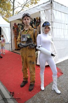 a man and woman dressed in costumes standing next to each other