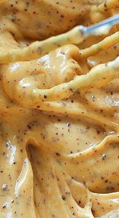 a bowl filled with yellow sauce on top of a table