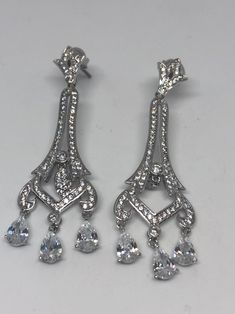 Vintage chandelier earrings silver diamond look Austrian crystal Handmade vintage silver rhodium over white bronze Crystal earrings These really look like white gold with diamond accents About 2.25 long All jewelry is shipped in a nice gift box. Check out our over a THOUSAND great reviews Classic Chandelier Earrings With Diamond Accents For Evening, Classic Drop Chandelier Earrings With Diamond Accents, Formal White Chandelier Earrings With Sparkling Stones, Dazzling Diamond White Chandelier Earrings As Gift, Dazzling Silver Chandelier Earrings With Cubic Zirconia, White Cubic Zirconia Chandelier Earrings For Formal Events, White Cubic Zirconia Chandelier Earrings For Formal Occasions, Silver Dazzling Cubic Zirconia Chandelier Earrings, Dazzling Silver Cubic Zirconia Chandelier Earrings