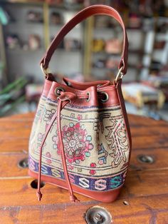 Thank you for visiting our shop!  It's very useful bag as shoulder and as crossbody bag.  This bag is spacious and holds a lot of things. Size         : 30cm x 27cm x 8cm Material  : wool / leather We select beautiful vintage kilims from all over the anatolian area and middle east area. and We do special wash for Kilim rug first, after that cut the kilim to remake unique kilim bags at our atelier  one by one. All products have been produced in a smoke-free environment.  Vintage kilim with colore Everyday Bucket Shoulder Bag With Leather Handles, Everyday Bucket Shape Satchel, Brown Bucket Bag With Detachable Handle For Daily Use, Everyday Use Hobo Bag With Detachable Strap, Everyday Bucket Hobo Bag With Detachable Strap, Everyday Use Satchel With Adjustable Strap, Everyday Bucket Shoulder Bag With Detachable Strap, Everyday Bucket Shape Shoulder Bag With Detachable Strap, Daily Use Leather Handle Bucket Bag