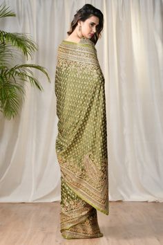 Editor's Note This set features a green embroidered paisley saree with unstitched blouse printed with garden of eden. Neck: Round Neck Sleeve Type: Short Sleeves Fabric: Satin Care: Dry Clean Only   Customize Your Outfit Can't find the size you're looking for? No stress. Just select size "Custom" while adding the item Saree Engagement, Draped Sarees, Desi Clothing, Engagement Saree, Wedding Sarees Online, Banaras Sarees, Indian Fashion Trends, Ritu Kumar, Indian Designer Suits