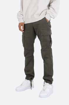 the Vintage Twill Cargo Pants are designed with a relaxed fit throughout with gusseting at the knee, cargo pockets at the side seam, a cinch-able waistband, zipper fly, and finishing off with elastic and cargo drawcords at the leg openings. details relaxed fit 100% cotton  zipper fly drawcords at leg opening model is 6’1, 140 lbs and wears a size 30 Cargo Pants Men Outfit, Mens Cargo Pants Outfit, Slim Cargo Pants Men, Camo Cargo Pants Outfit, Cargo Joggers Mens, Best Cargo Pants, Cargo Pants Outfit Men, Winter Bottoms, Pants Outfit Men