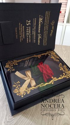 an open black box with a red rose in it