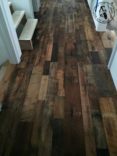 a hallway with wooden floors and white walls